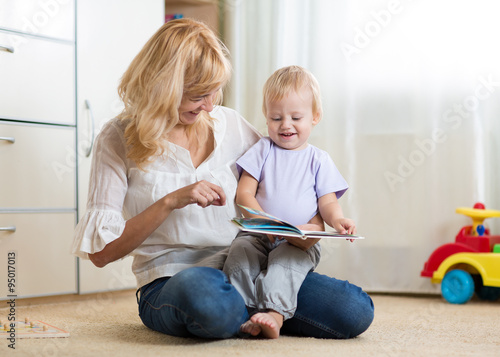 mom and kid boy read a book...