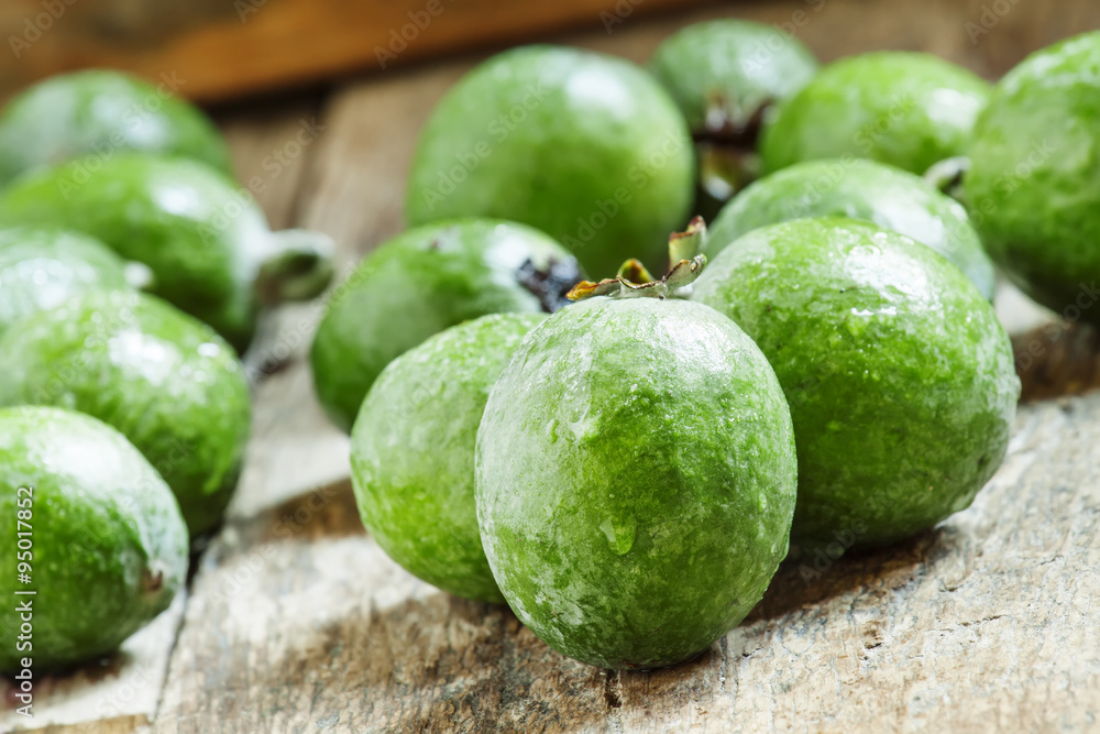 Fresh green feijoa on the old wooden background, selective focus Fresh green feijoa on the old wooden background, selective focus