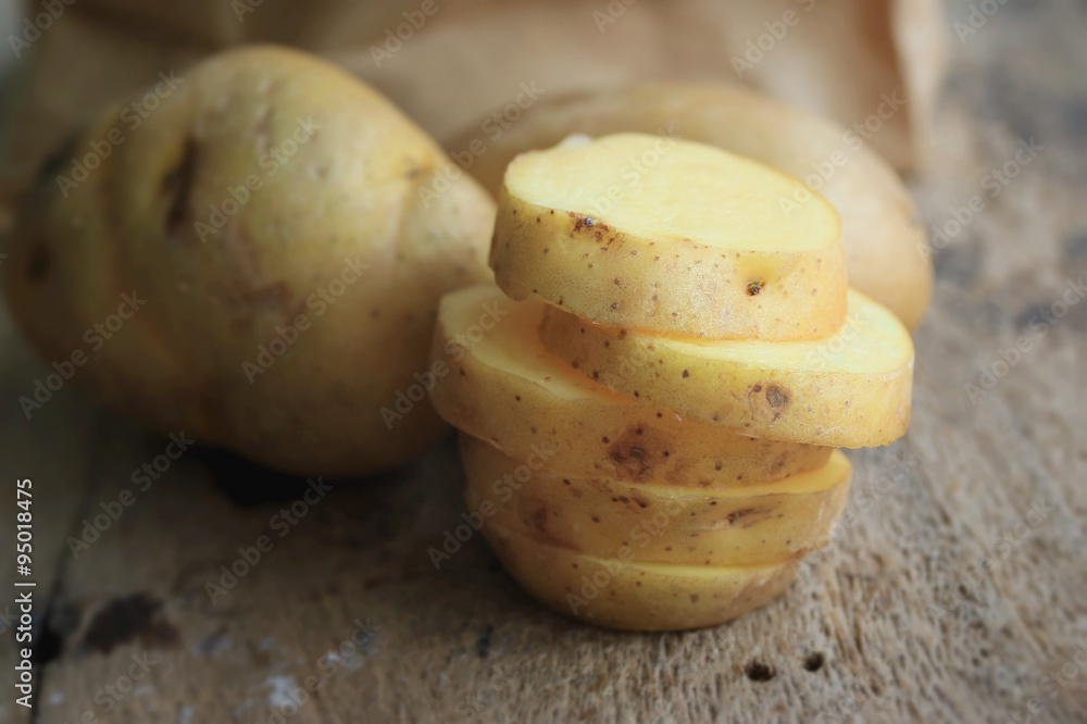 fresh potatoes on wood background