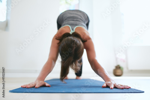 Woman doing Adho Mukha Svanasana yoga pose