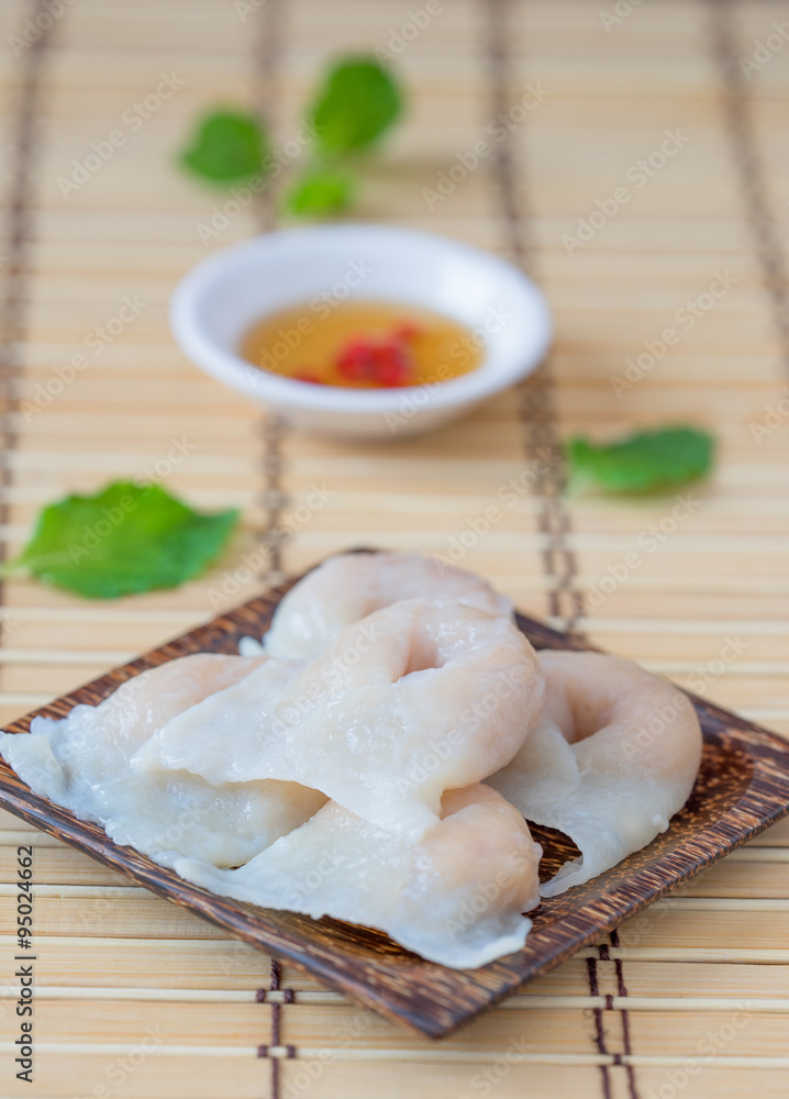 Fish dumplings in wooden dish on wood background.