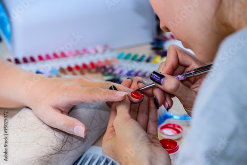 closeup of manicurist at work in the salon nail (shallow DOF; co