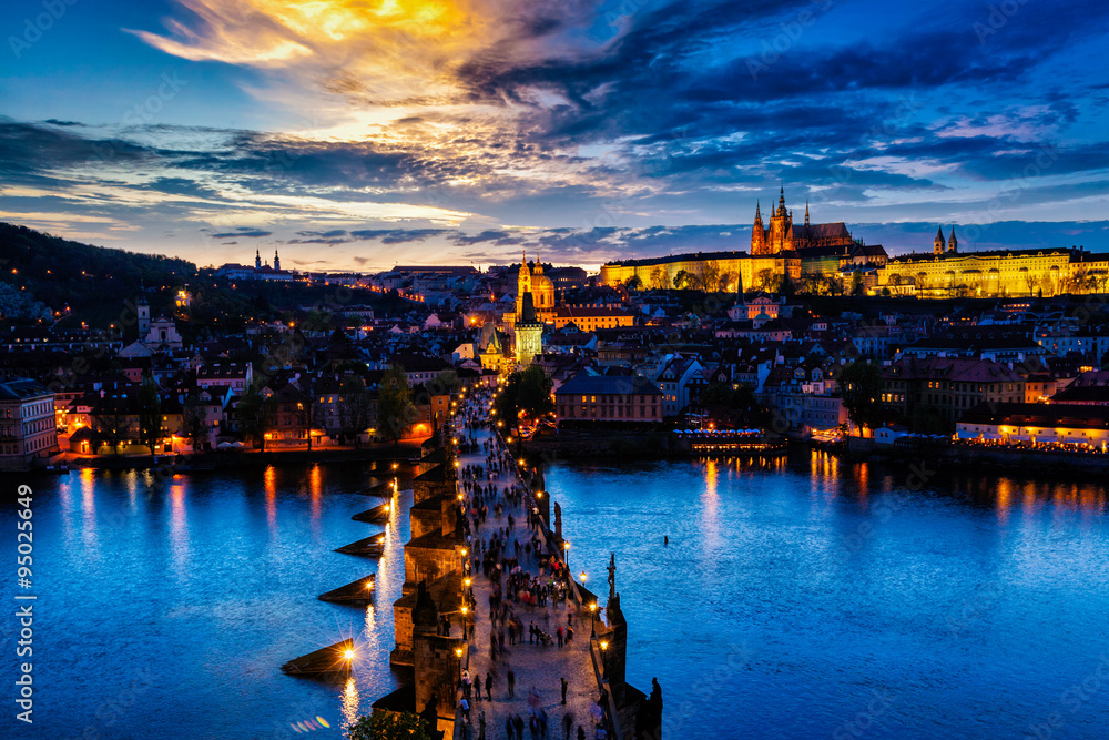 Night view of Prague castle and Charles Bridge over Vltava river