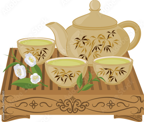 Kettle, small cups of green tea on a wooden table and flowers of tea. Set of isolated objects.
