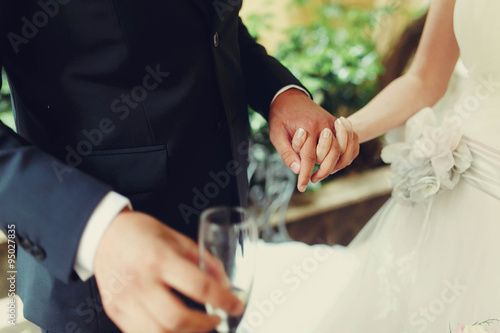amazing beautiful rich stylish bride and groom holding hands and