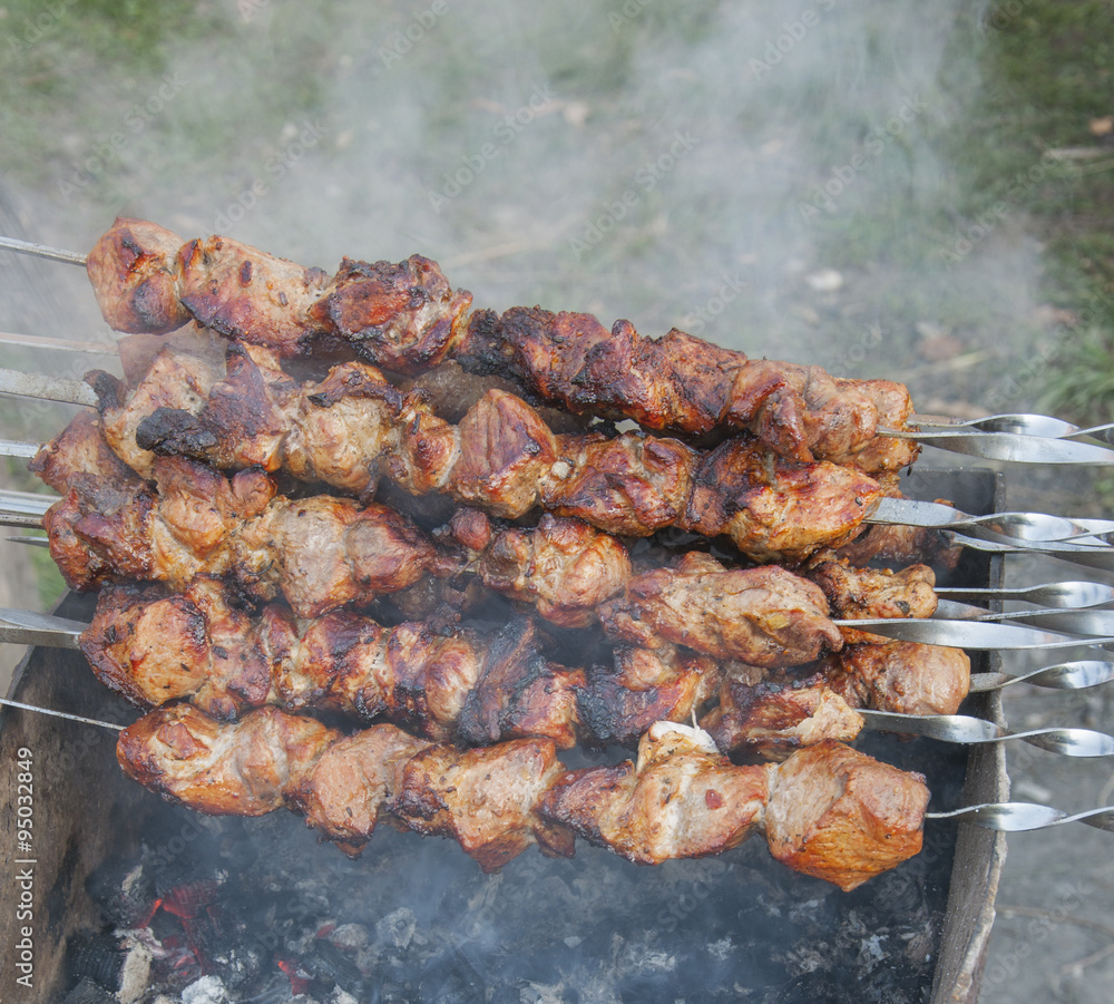 Skewers with meat on the barbecue grill Skewers with meat on the barbecue grill
