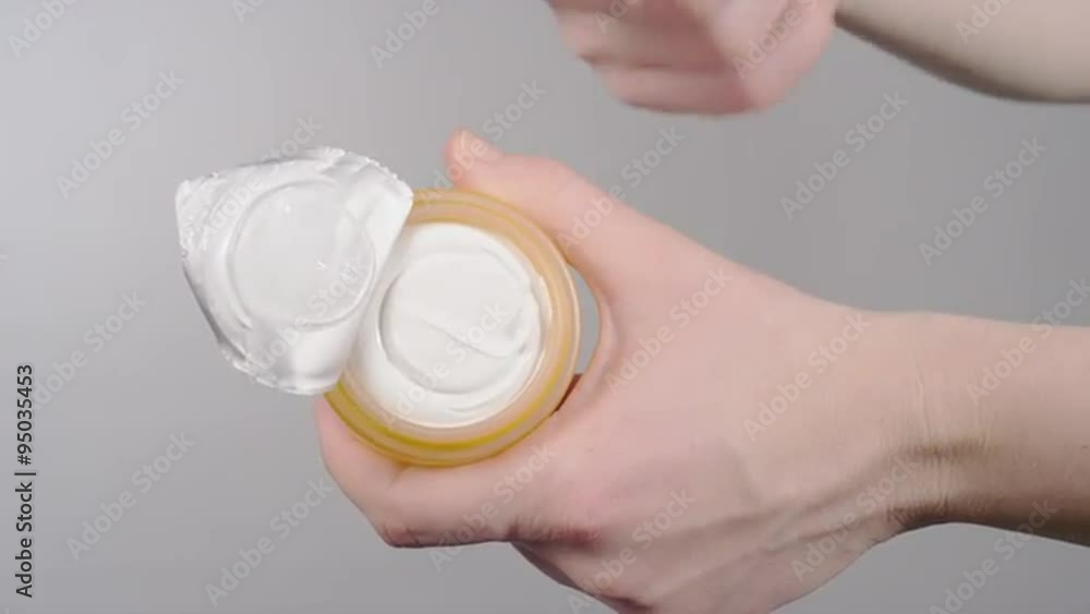 Taking face cream out of the jar Taking face cream out of the jar