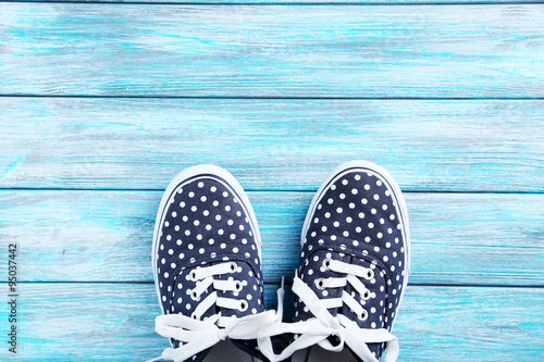 Female gumshoes on blue wooden background