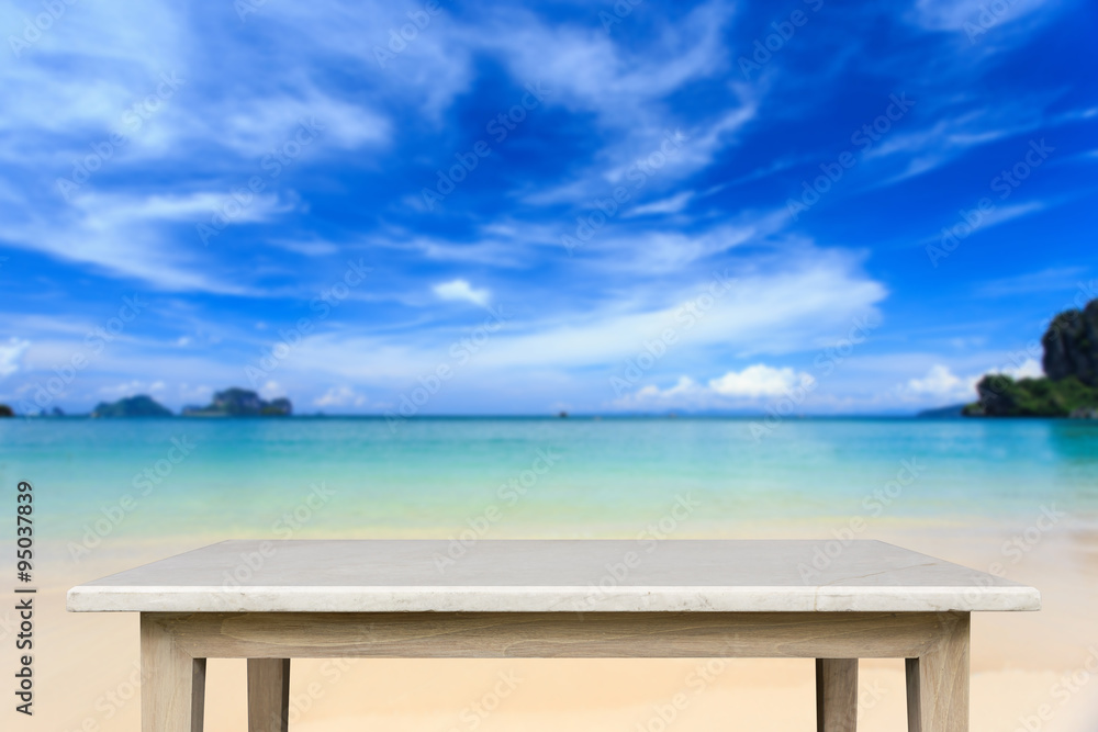 Empty top of natural stone table and view of tropical beach back