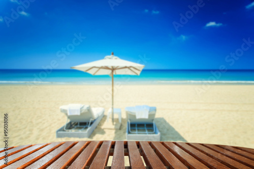 Empty top of wooden table and view of tropical beach © SKT Studio
