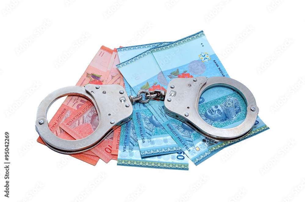 Handcuffs with money isolated over white background Handcuffs with money isolated over white background