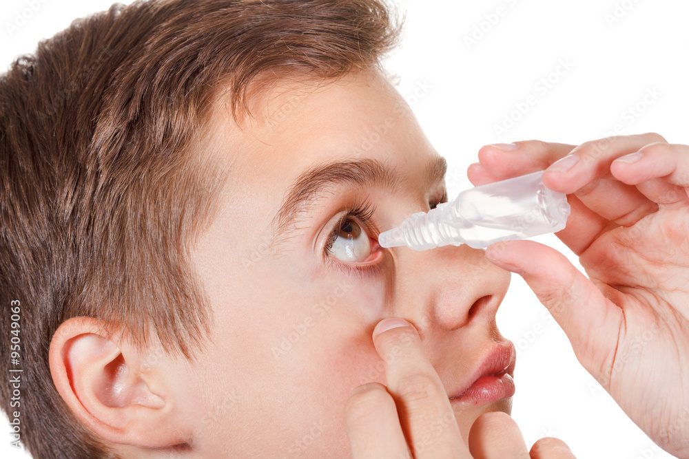 Boy applying eye drop Boy applying eye drop