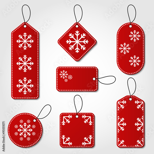 Christmas tag collection in red and white color. Red tag vector set in different shapes with snowflake design and hangers for price tags or gift cards.