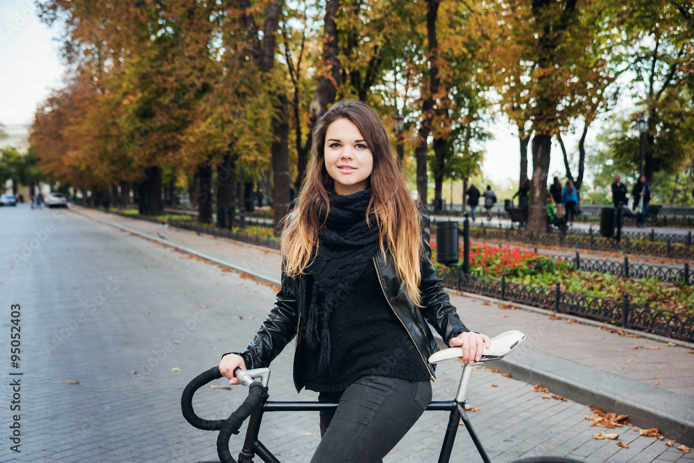 young female riding a bicycle, girl with fixed gear bike young female riding a bicycle, girl with fixed gear bike
