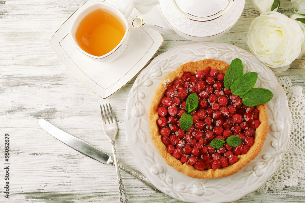Tart with raspberries and tasty tea, on color wooden background Tart with raspberries and tasty tea, on color wooden background