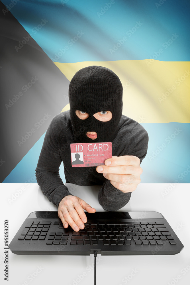 Hacker with flag on background holding ID card in hand - Bahamas Hacker with flag on background holding ID card in hand - Bahamas
