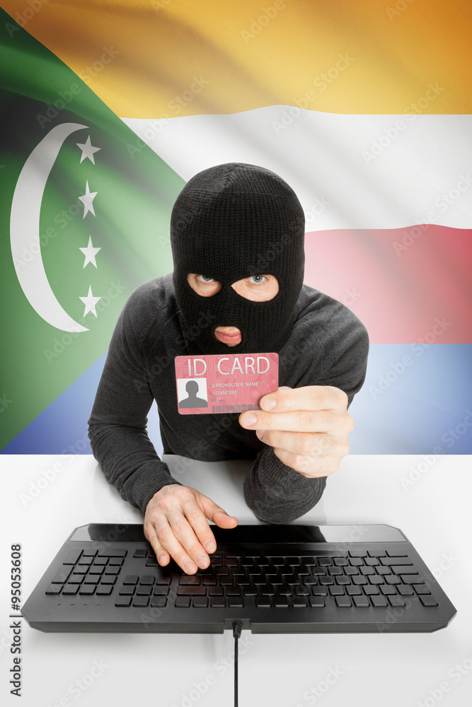 Hacker with flag on background holding ID card in hand - Comoros Hacker with flag on background holding ID card in hand - Comoros