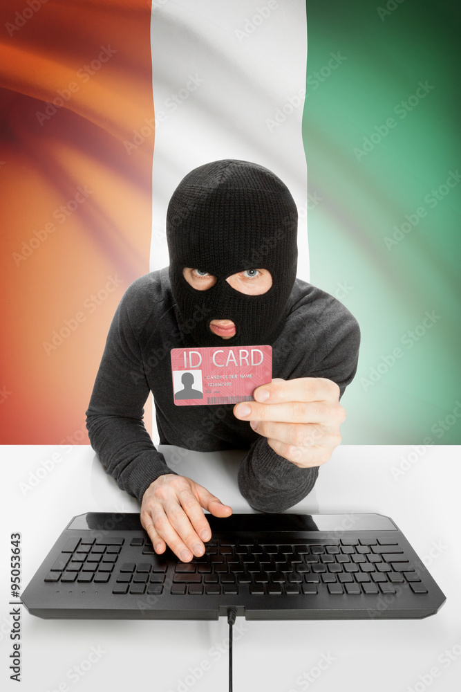 Hacker with flag on background holding ID card in hand - Ivory Coast Hacker with flag on background holding ID card in hand - Ivory Coast
