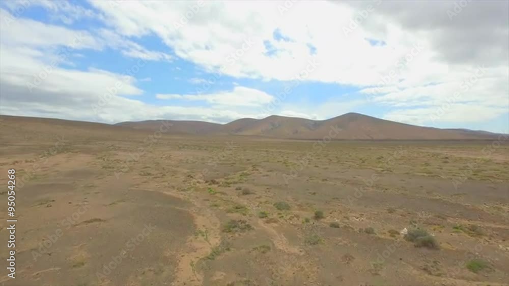 AERIAL: Flying towards the desert towards the large volcanoes AERIAL: Flying towards the desert towards the large volcanoes