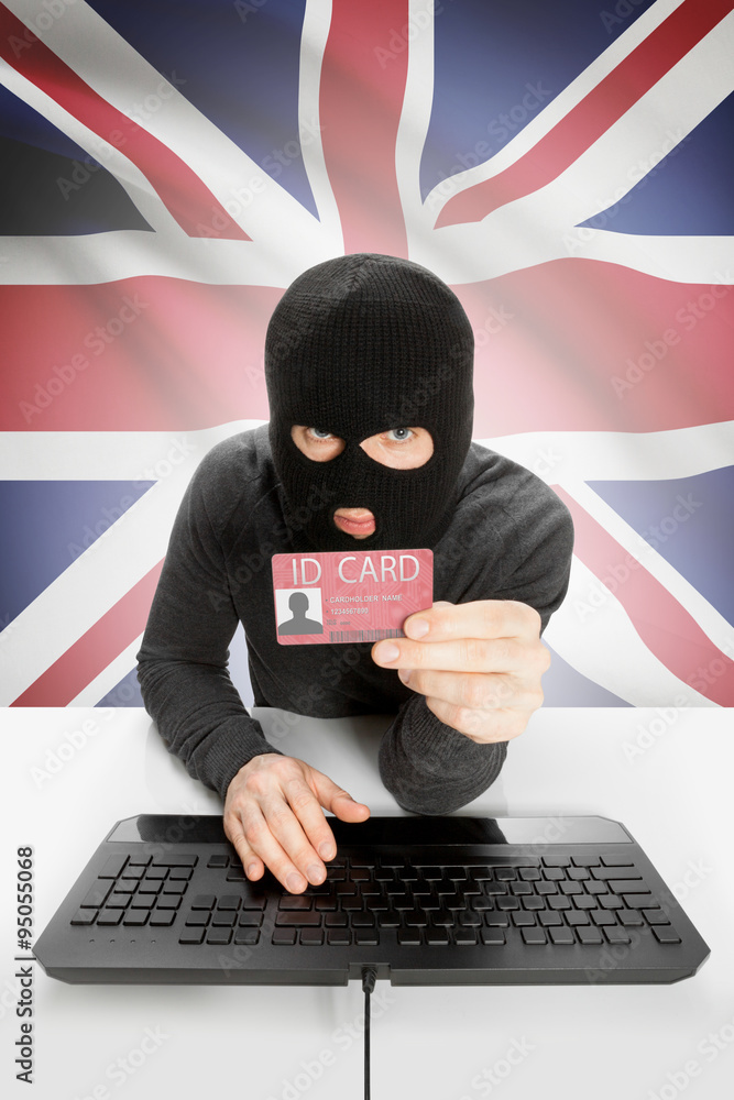 Hacker with flag on background holding ID card in hand - United Kingdom Hacker with flag on background holding ID card in hand - United Kingdom