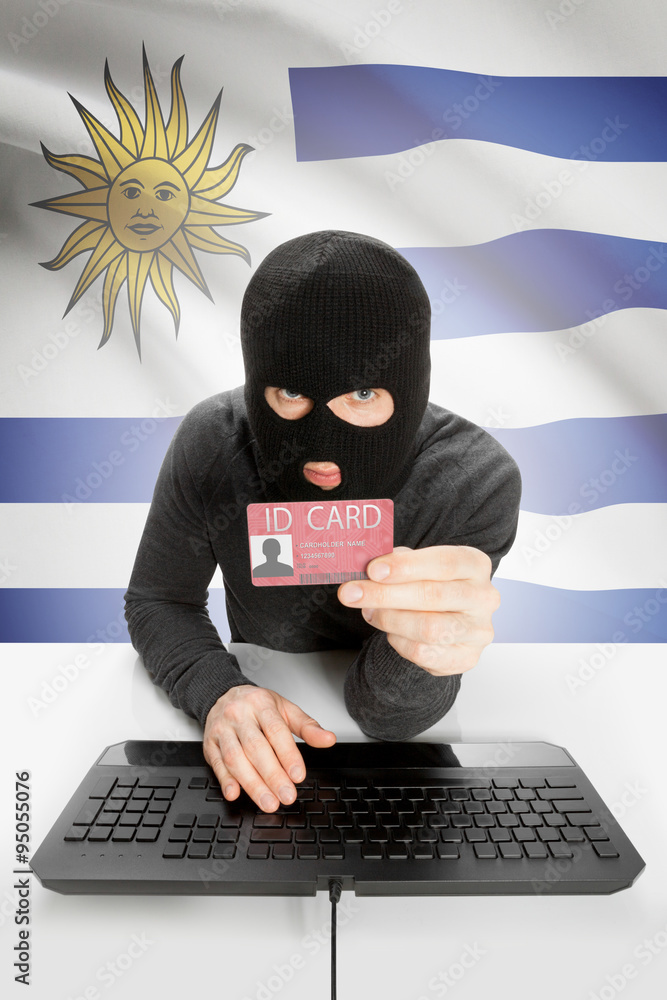 Hacker with flag on background holding ID card in hand - Uruguay Hacker with flag on background holding ID card in hand - Uruguay