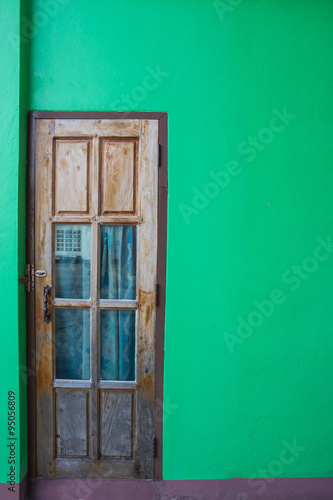 wooden door and green wall