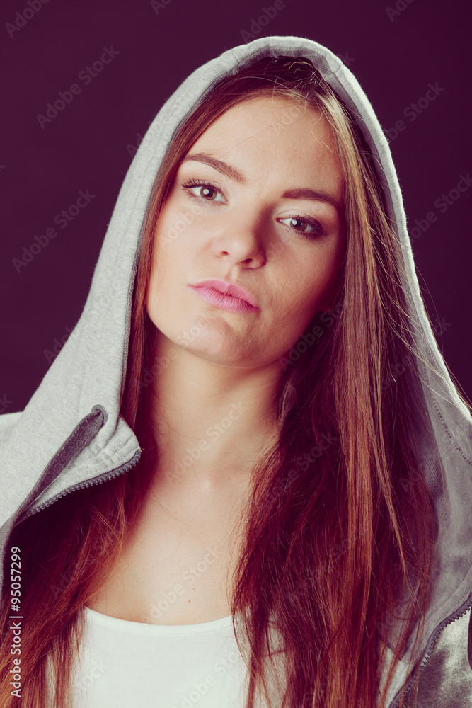 Obraz premium Portrait of pensive teenager girl in hood.