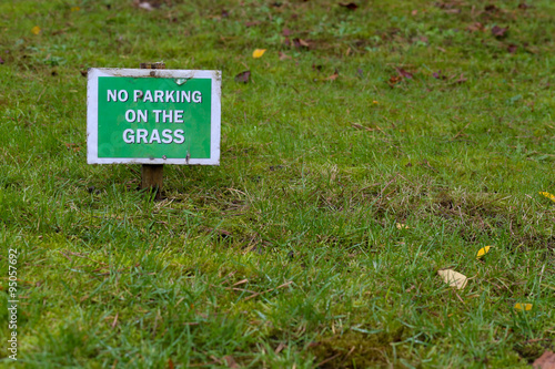No Parking On the Grass Sign Over Green Lawn