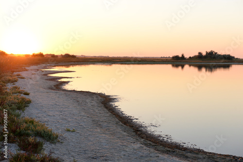 Colourful sunset over a wild beach near water