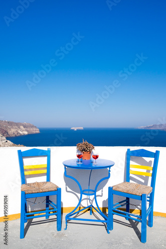 Blue chairs and table on a mediterranean balcony with nice view © Martin M303