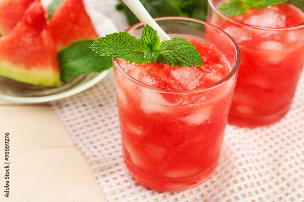 Cold watermelon drinks in glasses, on wooden table background Cold watermelon drinks in glasses, on wooden table background