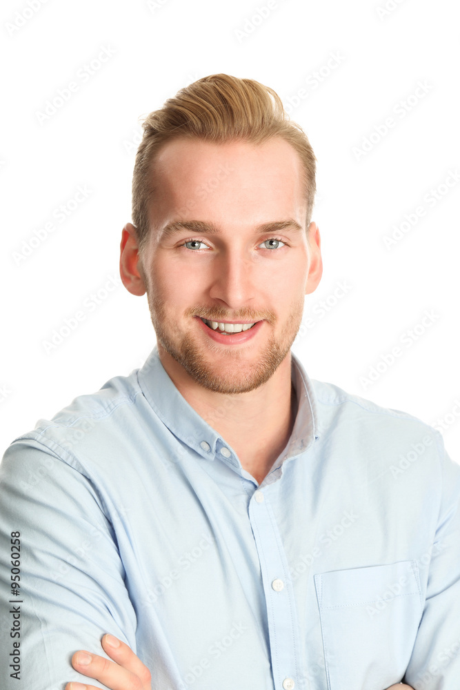 An attractive young man wearing a blue shirt with khaki pants, standing smiling towards camera against a white background. An attractive young man wearing a blue shirt with khaki pants, standing smiling towards camera against a white background.