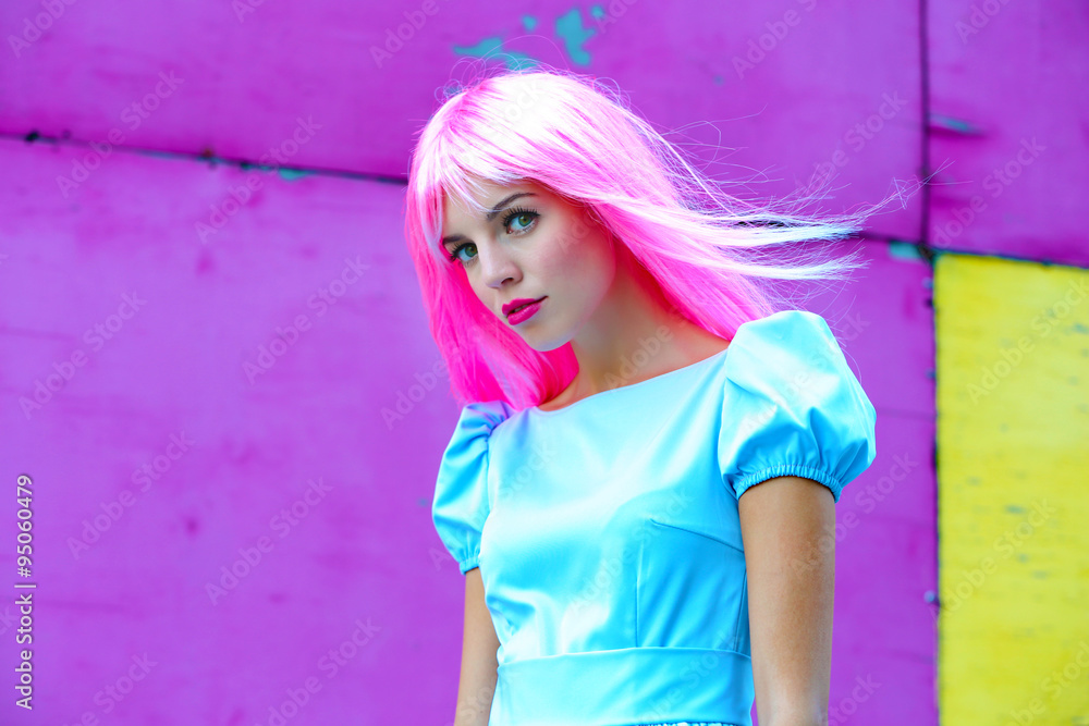 Portrait of beautiful woman with pink hairstyle on bright wall background Portrait of beautiful woman with pink hairstyle on bright wall background