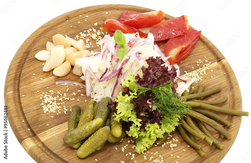 wooden plate with pickles on a white background Stock-Foto | Adobe Stock