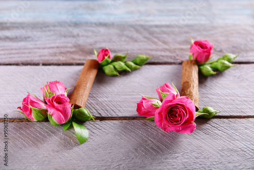 Creative music notes made of flowers on wooden background, close up
