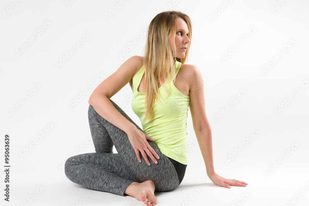 Blond woman doing yoga and stretching exercises Blond woman doing yoga and stretching exercises