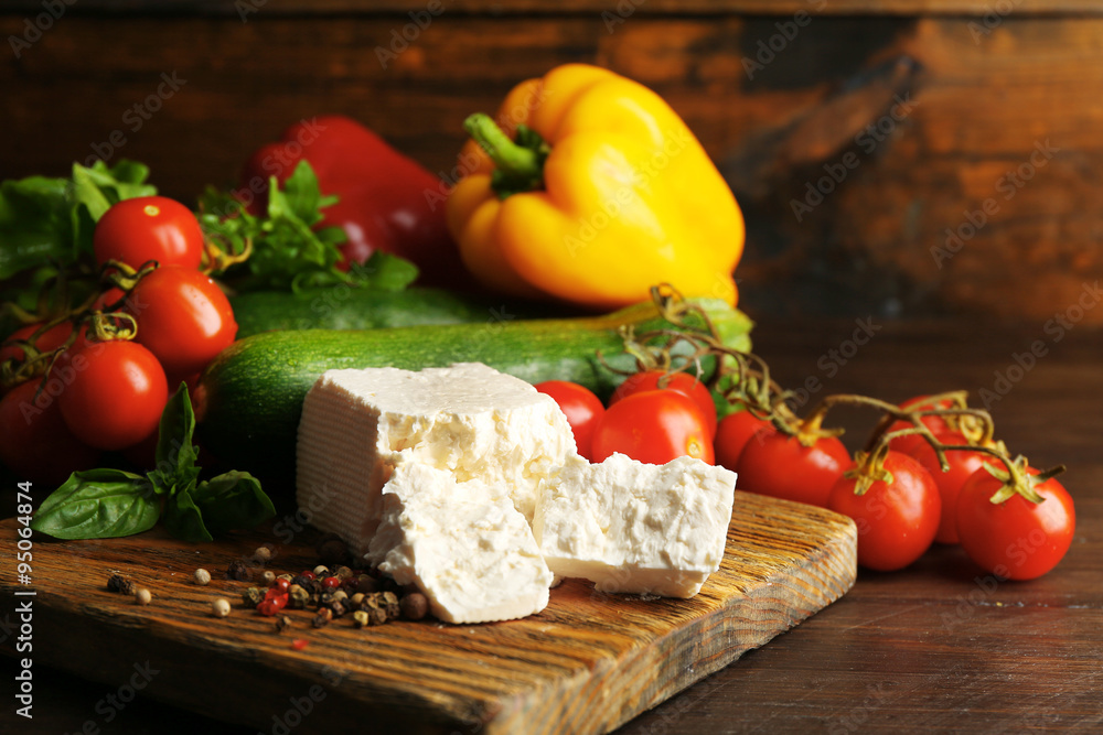 Fresh ingredients for preparing zucchini rolls on wooden background