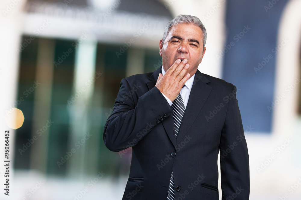 business man doing a tired gesture business man doing a tired gesture