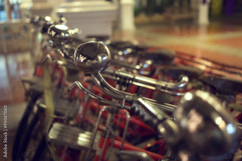 Fototapeta premium red retro bicycle on street, abstract blur image background