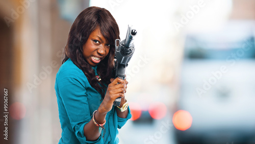 Schilderij op canvas black woman joking with a gun