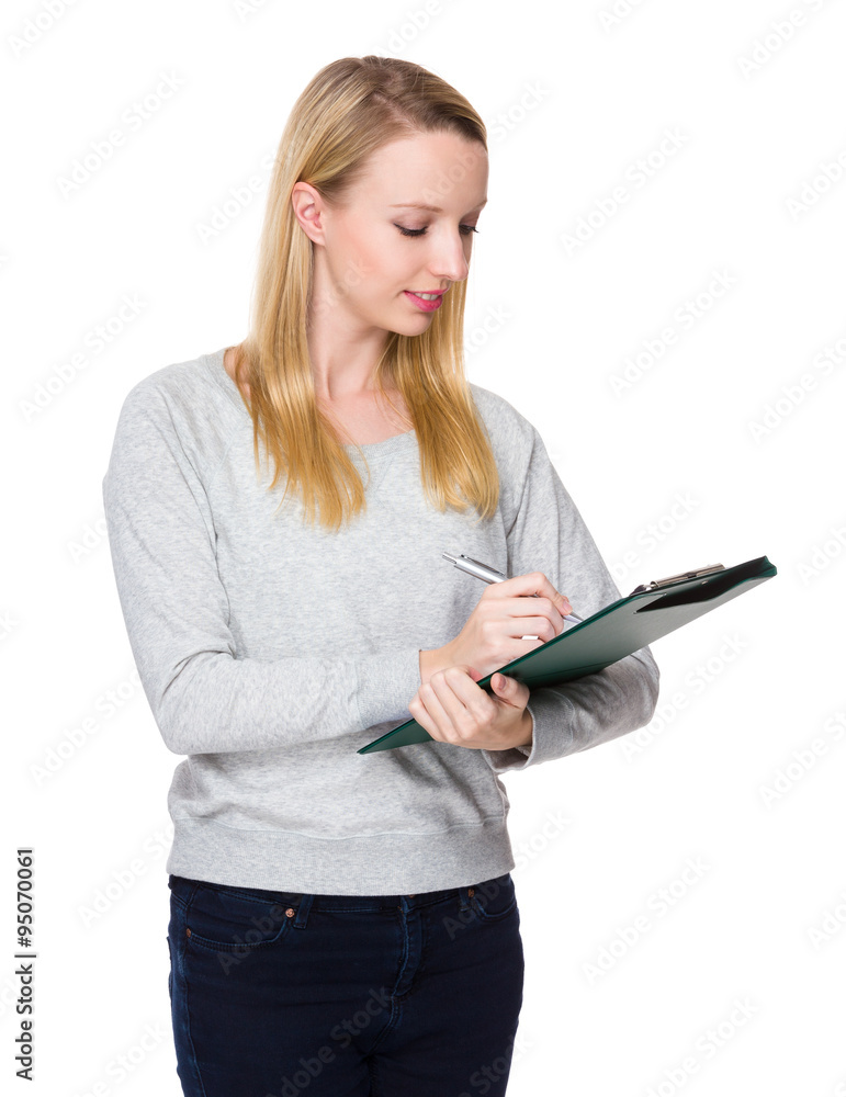 Young Woman write on clipboard Young Woman write on clipboard