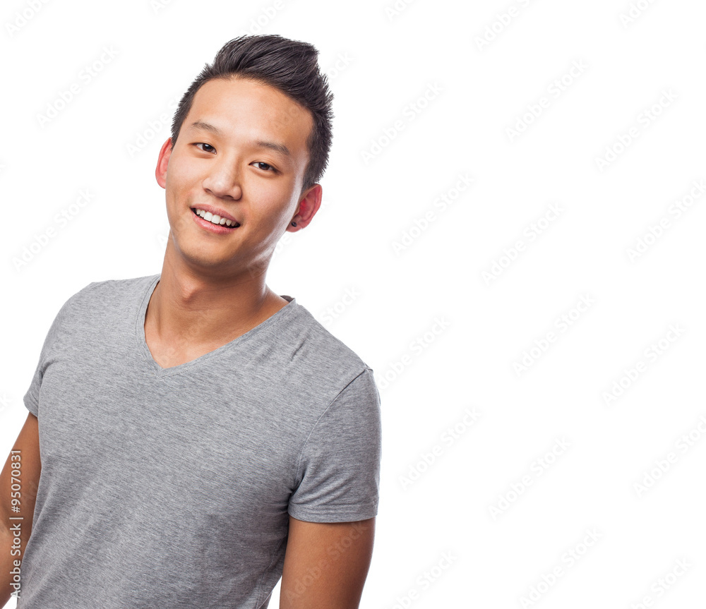 Handsome young asian man smiling wearing a grey shirt Handsome young asian man smiling wearing a grey shirt