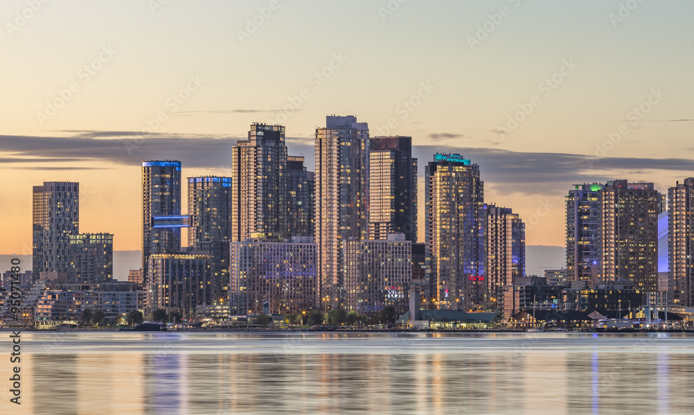 Obraz premium Toronto Harbourfront district skyline with the adjacent high-rise condo buildings - illuminated during sunset .