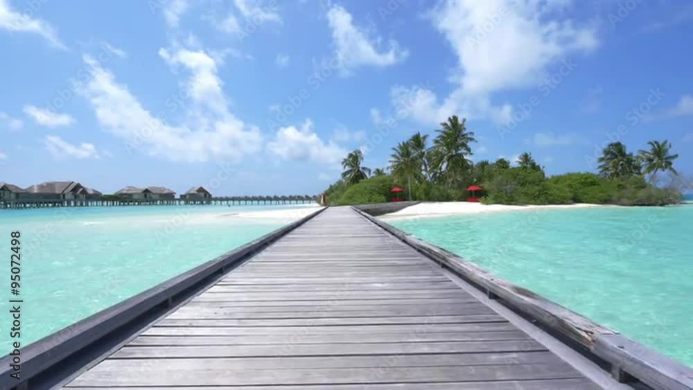 SLOW MOTION: Water villas in front of exotic white sand beach SLOW MOTION: Water villas in front of exotic white sand beach