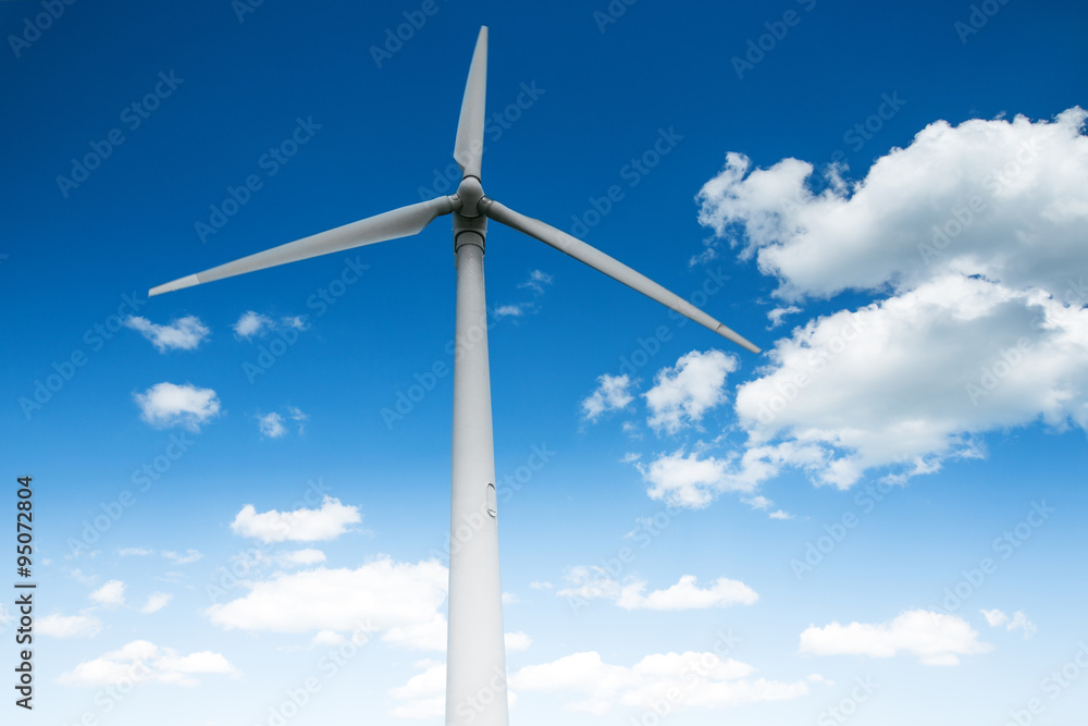 Wind energy turbine and fluffy clouds in the sky Wind energy turbine and fluffy clouds in the sky
