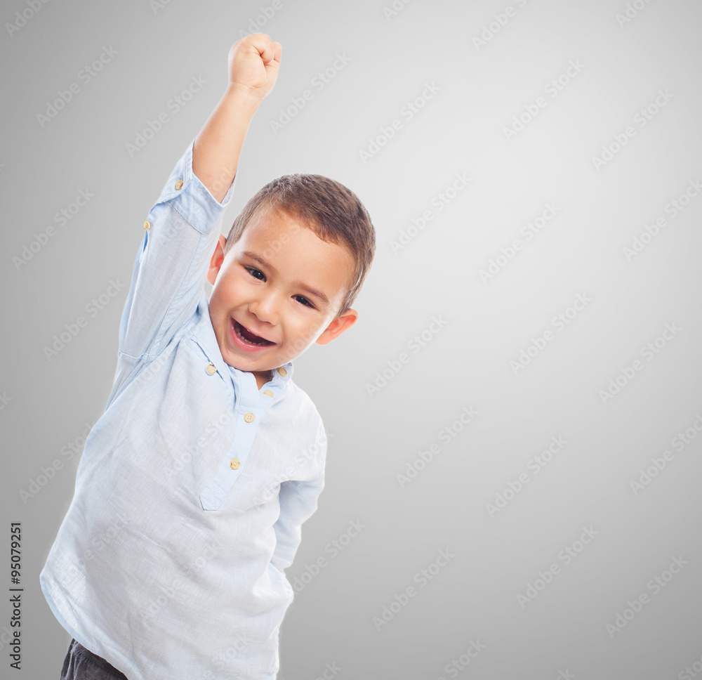 portrait of a little boy with winner gesture portrait of a little boy with winner gesture