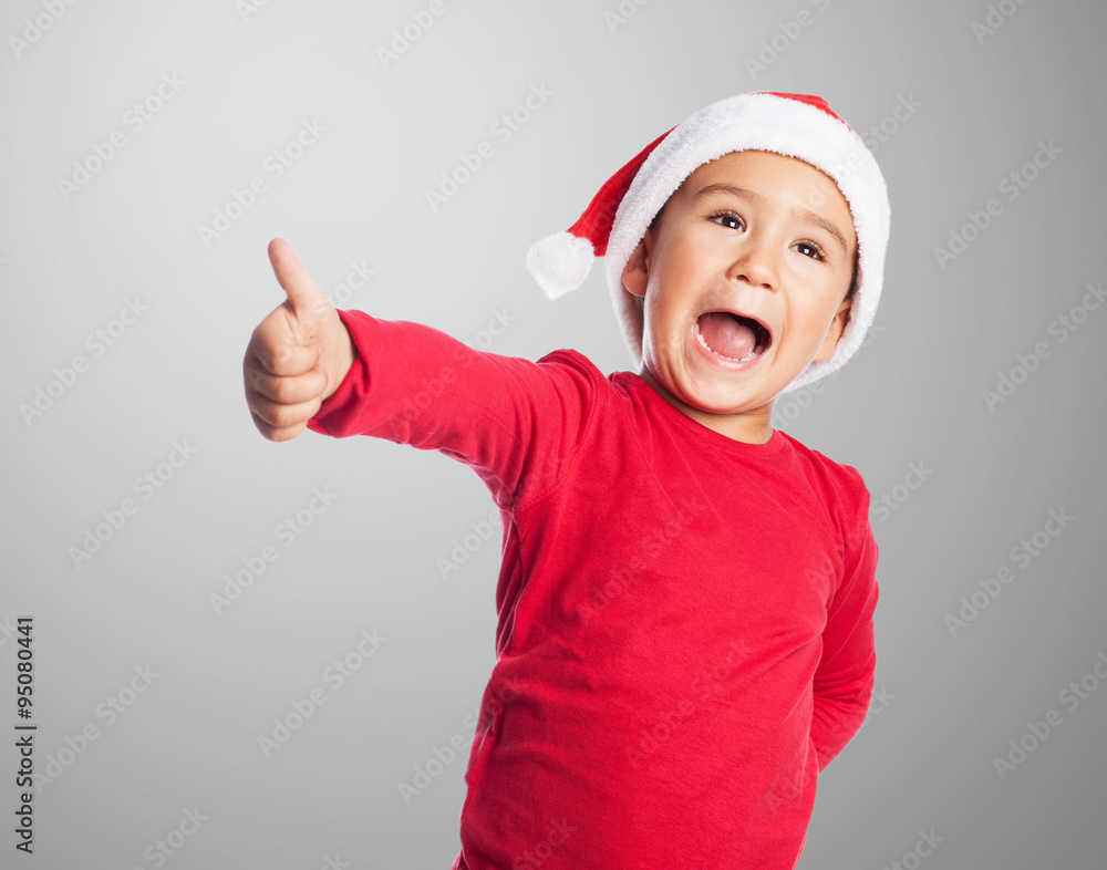 portrait of a little boy on christmas time with thumb up portrait of a little boy on christmas time with thumb up
