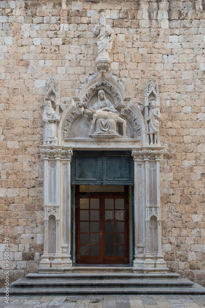 Door and statues at the entrance to the Franciscan Monastery at the Old Town in Dubrovnik, Croatia.