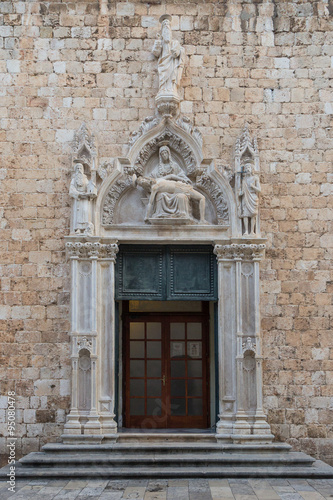 Door and statues at the entrance to the Franciscan Monastery at the Old Town in Dubrovnik, Croatia.