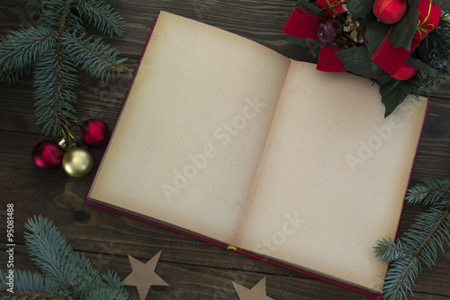 Red Christmas decorations and an open book